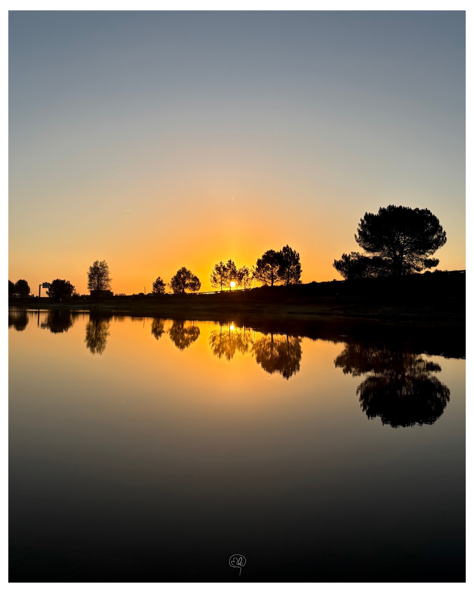 Coucher de soleil reflété sur un lac calme