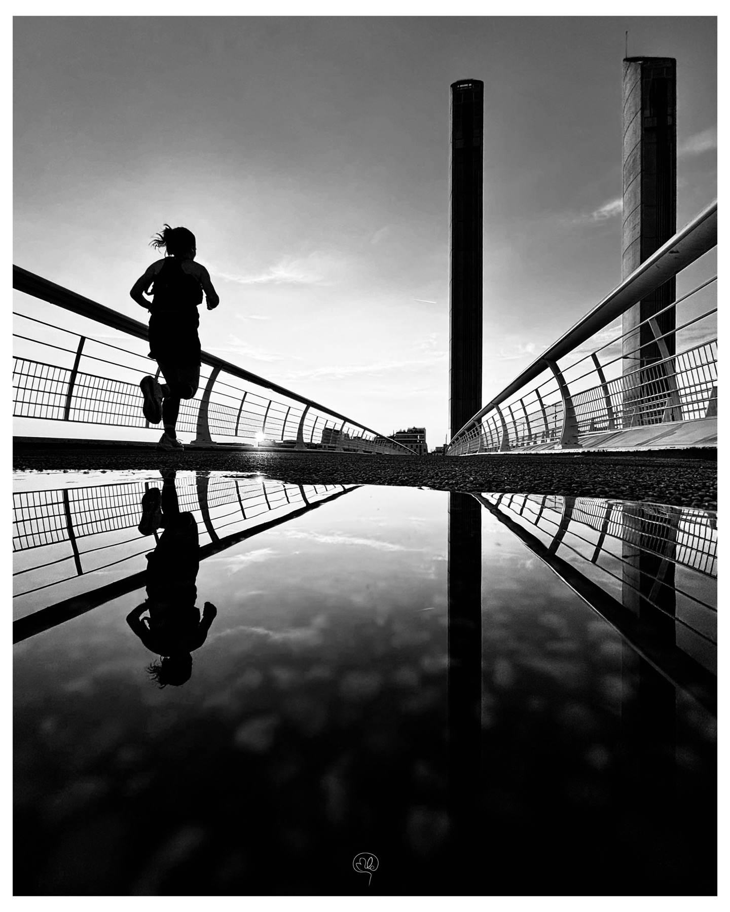 Silhouette d'une coureuse sur une passerelle et son reflet
